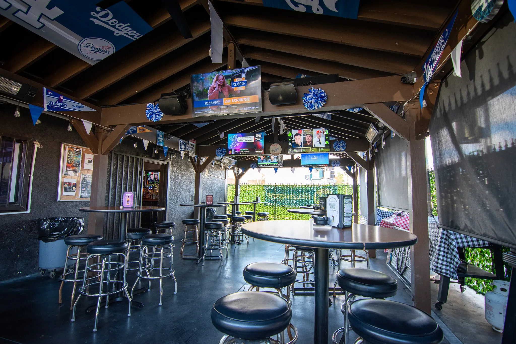 Covered outdoor patio at The Greatest Hawthorne with guests enjoying outside food