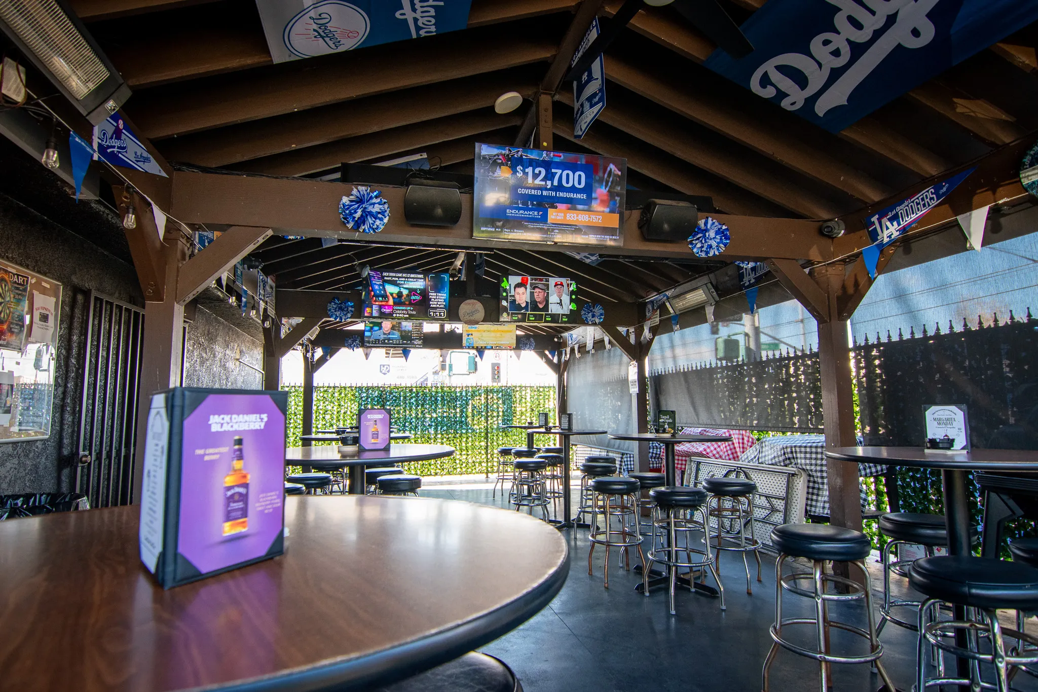 Guests relaxing with drinks and food on the patio at The Greatest Hawthorne
